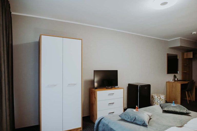 A hotel room in Sibiu equipped with a bed, television, and TV.