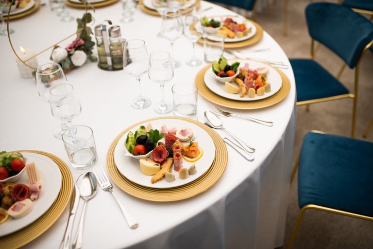 A round table with food and silverware on it at a hotel in Sibiu.
