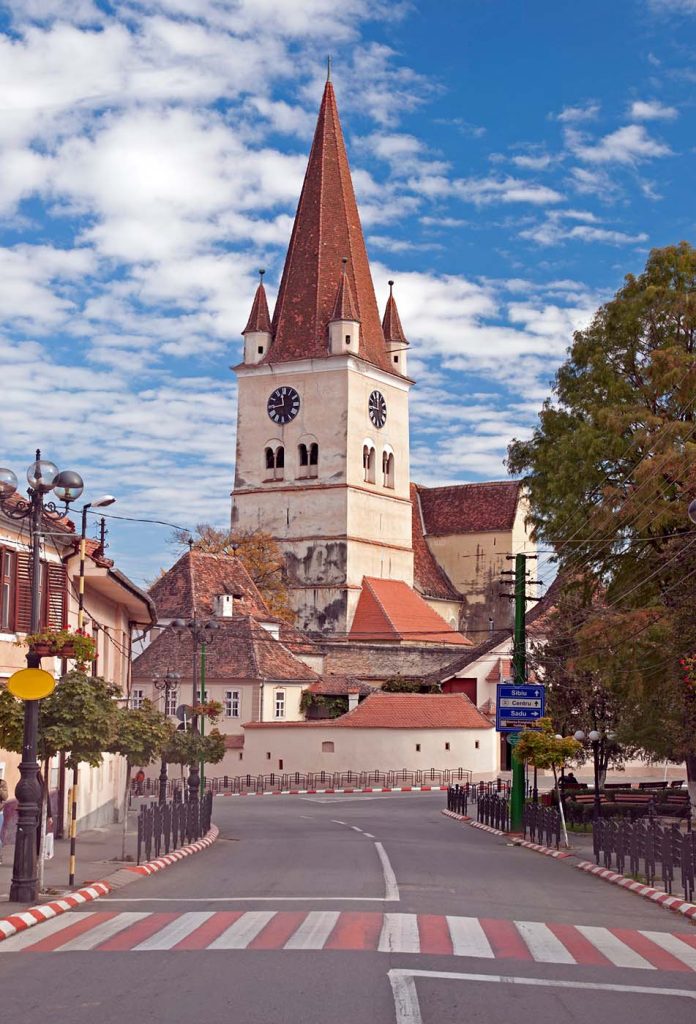 A church in the middle of a street in Cisnadie.