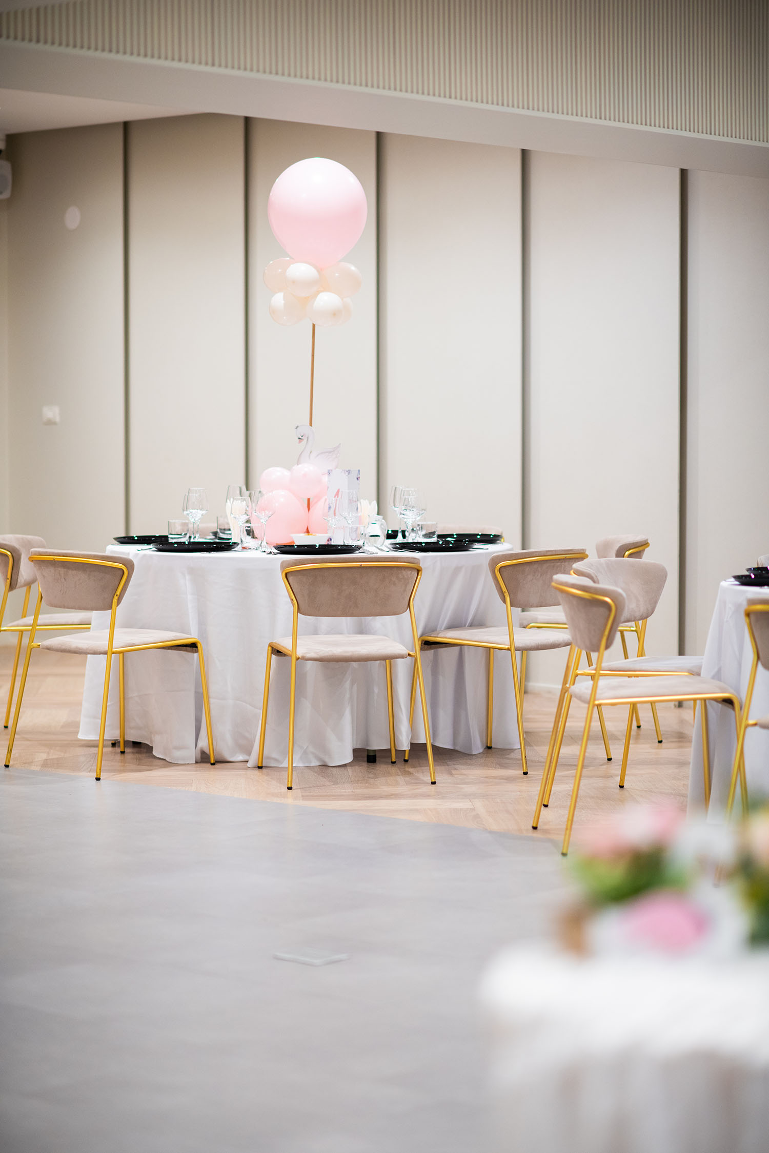 A white table with Epic Harmony balloons on it.
