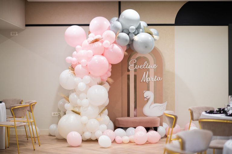 An Epic Harmony event venue featuring a balloon arch decorated with pink and white balloons.