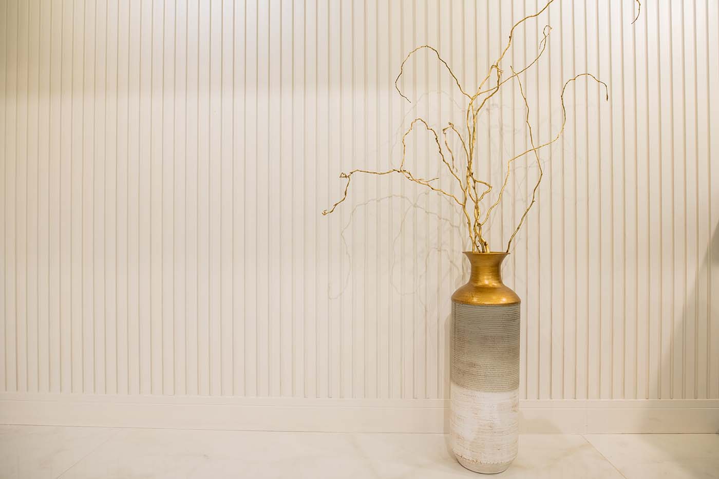 A gold vase sits in front of a white wall in a hotel in Cisnadie, Sibiu.