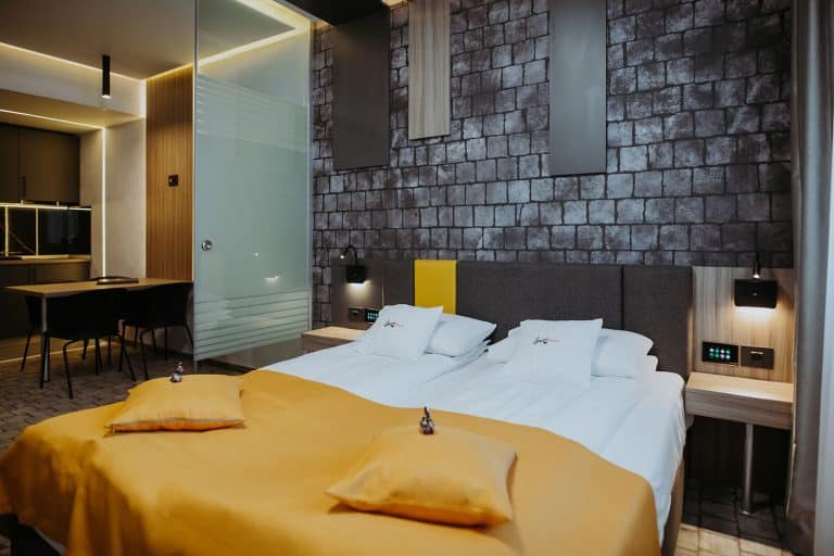 A hotel bed in Sibiu with yellow and black accents.