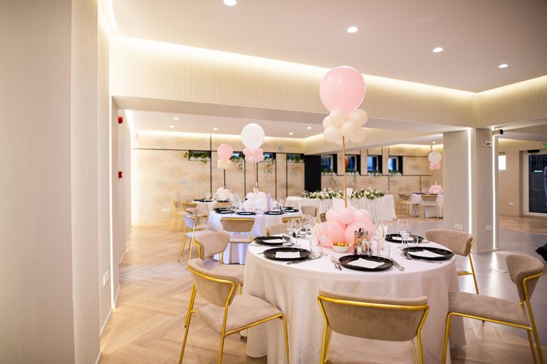 An Epic Harmony event room decorated with pink and white balloons.